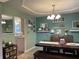 Open-concept dining area with dark table and modern decor is adjacent to the kitchen at 2925 Morgan Trl, Martinsville, IN 46151