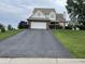 Traditional home exterior with a long driveway and mature landscaping at 2925 Morgan Trl, Martinsville, IN 46151