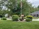 Front yard with mature trees, shrubs, and flag pole at 2925 Morgan Trl, Martinsville, IN 46151