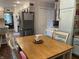 Bright kitchen features a wooden dining table, stainless steel refrigerator, and white cabinets at 2925 Morgan Trl, Martinsville, IN 46151
