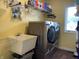 Laundry room featuring a modern washer and dryer, utility sink, and shelving at 2925 Morgan Trl, Martinsville, IN 46151