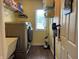 Laundry room featuring a modern washer and dryer, utility sink, and storage shelves at 2925 Morgan Trl, Martinsville, IN 46151