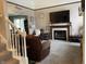 Inviting living room features a fireplace, large television, plush seating, and warm, neutral decor at 2925 Morgan Trl, Martinsville, IN 46151