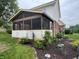 Enclosed back patio featuring screens, brick accents, white trim, and garden views at 2925 Morgan Trl, Martinsville, IN 46151