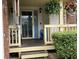 Covered porch features a blue door, a cozy bench, and well-manicured landscaping at 2925 Morgan Trl, Martinsville, IN 46151