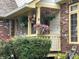 Charming porch featuring hanging flower baskets, decorative plants, and detailed trim work at 2925 Morgan Trl, Martinsville, IN 46151