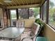 Screened-in porch with outdoor seating and a view of the yard and surrounding greenery at 2925 Morgan Trl, Martinsville, IN 46151
