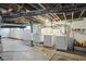 Unfinished basement with painted walls, exposed pipes, and laundry appliances at 3307 N College Ave, Indianapolis, IN 46205