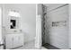 This bathroom features grey tile and a sleek shower with a built-in niche and a classic vanity at 3307 N College Ave, Indianapolis, IN 46205
