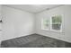 This bedroom has gray carpet, and white walls and trim. The room gets plenty of natural light from the window at 3307 N College Ave, Indianapolis, IN 46205