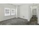 Bright bedroom with neutral carpet, white walls, and windows with blinds at 3307 N College Ave, Indianapolis, IN 46205