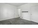 This bedroom features fresh white paint, neutral carpet, and an alcove door adding character at 3307 N College Ave, Indianapolis, IN 46205