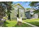 Front view of green two-story home with a well-manicured lawn at 3307 N College Ave, Indianapolis, IN 46205