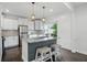 Modern kitchen featuring stainless steel appliances, a center island, and ample cabinet space at 3307 N College Ave, Indianapolis, IN 46205