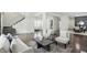 Open concept living room area with hardwood floors, neutral walls, and an open staircase at 3307 N College Ave, Indianapolis, IN 46205