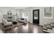 Bright living room featuring hardwood floors, a fireplace, and a modern interior at 3307 N College Ave, Indianapolis, IN 46205