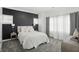 This main bedroom features plush carpet, a striking accent wall, and bright, neutral-toned decor at 3307 N College Ave, Indianapolis, IN 46205