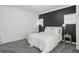 Spacious main bedroom with a large bed, decorative pillows, and modern neutral decor at 3307 N College Ave, Indianapolis, IN 46205