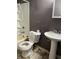 Functional bathroom featuring a bathtub-shower combo, toilet, and pedestal sink, ready for essential needs at 3320 E 26Th St, Indianapolis, IN 46218