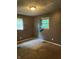 Compact bedroom features neutral carpet, two windows, and functional electrical outlets, ready for essential living at 3320 E 26Th St, Indianapolis, IN 46218