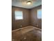 Modest bedroom features neutral carpet, two windows with blinds, and functional electrical outlets, ready for personalized touch at 3320 E 26Th St, Indianapolis, IN 46218