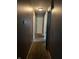 Narrow hallway featuring neutral carpet, a ceiling light, and several doors, providing access to different areas of the house at 3320 E 26Th St, Indianapolis, IN 46218