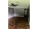The living room features hardwood flooring, a ceiling fan, and a doorway leading to other areas of the house at 3320 E 26Th St, Indianapolis, IN 46218