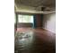 Spacious living room features hardwood floors, large window and ceiling fan, ready for personalized updates and comfortable living at 3320 E 26Th St, Indianapolis, IN 46218