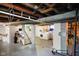 Spacious unfinished basement area with an open ceiling and laundry setup in the distance at 3329 Main St, Anderson, IN 46013
