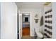 Bathroom with gray and white striped shower curtain, toilet and a view to the bedroom at 3329 Main St, Anderson, IN 46013