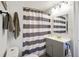 Well lit bathroom featuring a gray vanity, striped shower curtain and neutral colored walls at 3329 Main St, Anderson, IN 46013