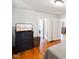 Bright bedroom showing hardwood floors, and doorway to other rooms of the house at 3329 Main St, Anderson, IN 46013