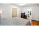 Bedroom with hardwood floors, neutral walls and ensuite bathroom featuring a dresser with TV on top at 3329 Main St, Anderson, IN 46013