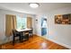 Bright dining area with hardwood floors, large window, and a doorway to kitchen at 3329 Main St, Anderson, IN 46013