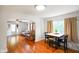 Bright dining area featuring hardwood floors, an archway to living room, and natural light at 3329 Main St, Anderson, IN 46013