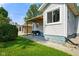 Exterior view shows the side of a well-maintained home with tidy landscaping and a covered patio at 3329 Main St, Anderson, IN 46013