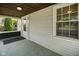 View of the covered front porch, showing the entrance door and wood ceiling at 3329 Main St, Anderson, IN 46013