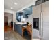 Bright kitchen featuring blue cabinets, wooden island, and stainless steel refrigerator at 3329 Main St, Anderson, IN 46013
