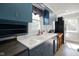 Bright kitchen featuring white double basin sink, blue cabinets, and butcher block countertop with natural light at 3329 Main St, Anderson, IN 46013