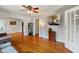 Bright living room with hardwood floors, ceiling fan, and a decorative wall-mounted screen at 3329 Main St, Anderson, IN 46013