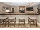 Basement wet bar with seating area and wood countertop with stools, ideal for relaxing at 3429 Woodham Pl, Carmel, IN 46033
