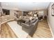 Open-concept basement featuring a bar, multiple seating areas, and stylish decor at 3429 Woodham Pl, Carmel, IN 46033