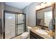Bathroom featuring granite countertop, dark wood cabinets, and framed glass shower at 3429 Woodham Pl, Carmel, IN 46033