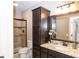 Elegant bathroom with granite countertops, dark wood cabinetry, and a glass-enclosed shower at 3429 Woodham Pl, Carmel, IN 46033