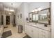 Bright bathroom featuring a double vanity, granite countertops, and large mirror, complemented by stylish lighting at 3429 Woodham Pl, Carmel, IN 46033