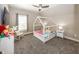 Charming bedroom with unique house-shaped bed frame, neutral colors, and whimsical decor at 3429 Woodham Pl, Carmel, IN 46033