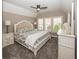 Cozy bedroom featuring neutral tones, a ceiling fan, a comfortable bed, and ample natural light at 3429 Woodham Pl, Carmel, IN 46033