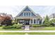 Charming home with blue shingles, stone accents, manicured lawn, and inviting curb appeal at 3429 Woodham Pl, Carmel, IN 46033