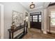 Welcoming foyer with hardwood floors, console table, decorative art, and large front door at 3429 Woodham Pl, Carmel, IN 46033