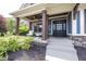 Inviting front porch with stylish seating and dark brown support pillars at 3429 Woodham Pl, Carmel, IN 46033